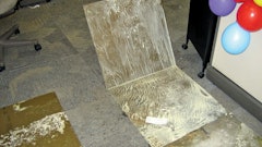 Water vapor that traveled through the concrete slab reached dew point and re-emulsified the water-based glue that once secured these carpet tiles to the concrete substrate.