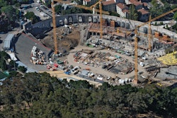 An aerial shot of Memorial Stadium shows site work taking place in the majority of the stadium and the original concrete facade around the structure.