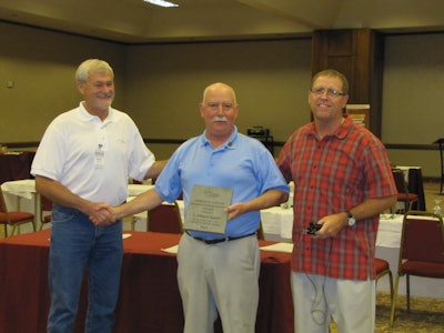 Scott Smith, left, and Barry Herbert, right, present CFA Executive Director Ed Sauter, middle, with the 2012 Robert D. Sawyer Distinguished Service Award at the CFA Summer Convention in Grand Traverse, Mich.
