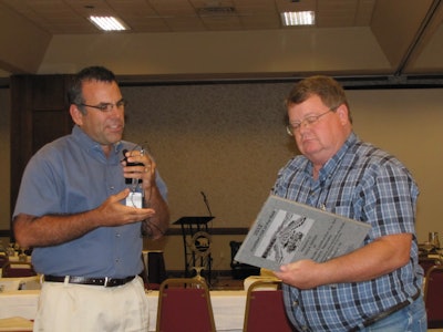 Jim Baty, left, presents Lance Jordan, right, with the CFA Contractor of the Year award.