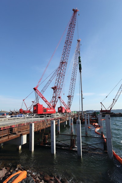 Four Manitowoc crawler cranes are working on an expansion project at Logan International Airport in Boston to lengthen the airport's longest west-to-east runway by building a 600- by 300-ft. pier out into Boston Harbor.