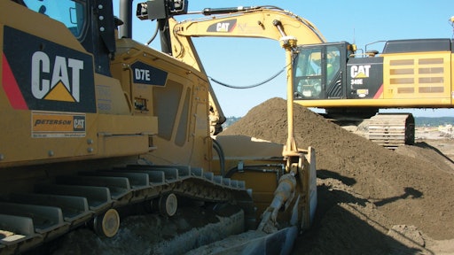 K&E Excavating’s D7E uses half the fuel of the company’s previous model. The company owns 115 pieces of Cat equipment, including the D7E and a 349E (shown working in the background).
