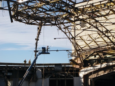 The dome's roofing materials - a compilation of over 16 inches of lightweight concrete, foam insulation, built-up roofing material and thin copper sheeting - were removed manually.