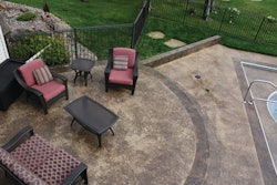 Alchemy used mottled light browns for its backyard patio and pool deck project and highlighted the retaining walls/benches, patio steps and pool deck trim with a darker color.
