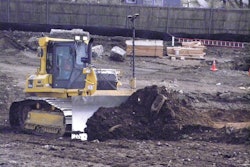 Komatsu dozer equipped with twin antenna Topcon 3D-MC2 automated grade control system levels out a steep slope.