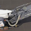 The basic configuration of the Wirtgen milling machine starts with a cutter drum inside the cutter housing where the asphalt is milled up, and that drum is constructed so the millings are augured to the center of the housing where it is ejected through a window onto a conveyor.