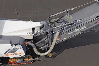 The basic configuration of the Wirtgen milling machine starts with a cutter drum inside the cutter housing where the asphalt is milled up, and that drum is constructed so the millings are augured to the center of the housing where it is ejected through a window onto a conveyor.