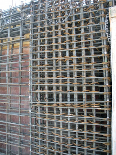 Reinforcing steel is so congested in the shear wall boundary element (right side of photo) that concrete must be placed in the less heavily reinforced shear wall section (left side of photo) and vibrated at that point to move it laterally into the boundary element.