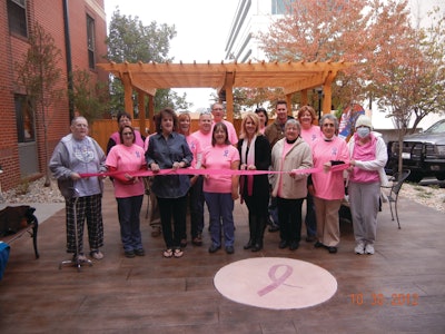 The American Cancer Society’s Hope Lodge in Kansas City, Mo., got a patio makeover thanks to time and materials donations from local contractors and suppliers. Volunteers stamped the integrally colored patio with a faux wood plank design and applied an antique finish. A circle of integrally colored pink concrete features a stenciled ribbon design.