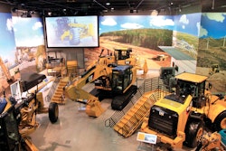 An overview of an equipment display at the Caterpillar Visitors Center, where deep exposed aggregate polished concrete floors were designed to emulate a gravel pit or construction site.