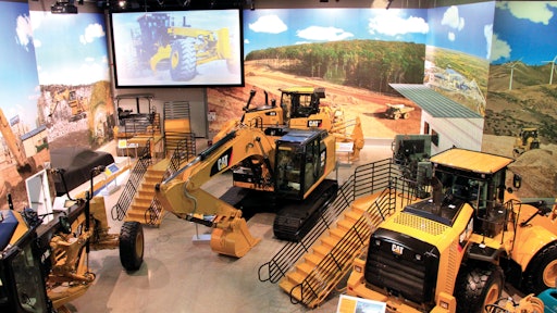 An overview of an equipment display at the Caterpillar Visitors Center, where deep exposed aggregate polished concrete floors were designed to emulate a gravel pit or construction site.