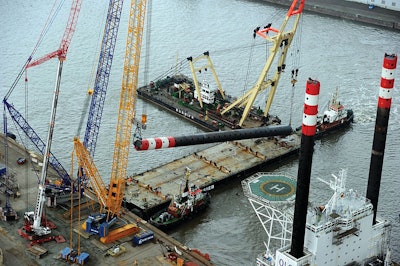 The Sarens Group recently lifted two sets of four jackup legs onto two offshore installation vessels. These legs enable installation vessels to lift themselves up from the water in the middle of the sea while installing wind turbines.