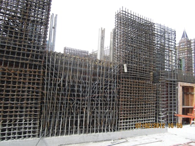 As the photos demonstrate, there are heavily reinforced areas within the shear walls. The beam in the center of the photos has 32 #11 bars, 21 feet long, installed in an “X” pattern across the opening and fully developed into the boundary elements. The design in this location and at the typical boundary elements effectively eliminated the use of internal vibration in much of the walls.