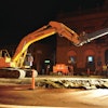 A LiuGong 936D excavator drives an I-beam into the ground to install trench box walls prior to pipeline replacement.