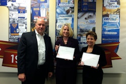 Rich Johnson, The Blue Book president, presents a symbolic 'Certificate of Ownership' to two of the company's most tenured employees: (L to R) Meg Hillmann, manager of paid order processing, and 30+ year veteran and Mary Ann Crisci, supervisor of customer service.