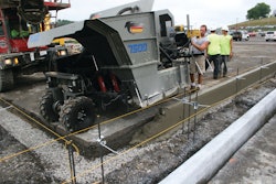 The mid-size curb and gutter machine pours close to the 90-degree transition point.