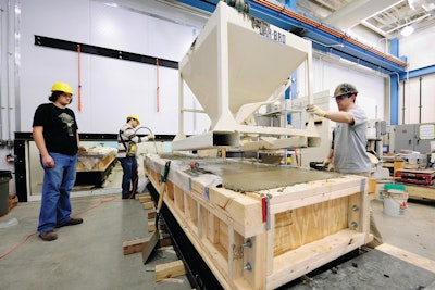 From left: Purdue University graduate students Paul Imbrock, Kambiz Raoufi and John Schlitter pour concrete for a test specimen in research to improve Indiana bridges. (Purdue University photo/Andy Hancock)