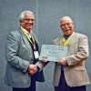 Bob Long (left), on behalf of Thermomass, accepts the 2013 Tilt-Up Concrete Association Robert Aiken Innovation Award from TCA Executive Director Ed Sauter (right).