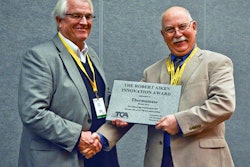 Bob Long (left), on behalf of Thermomass, accepts the 2013 Tilt-Up Concrete Association Robert Aiken Innovation Award from TCA Executive Director Ed Sauter (right).