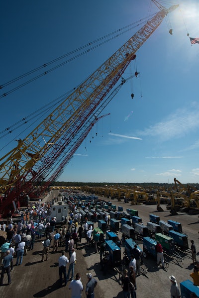 A crowd of bidders gathers around a selection of cranes on day three of the Ritchie Bros. 2013 Orlando, FL, auction.