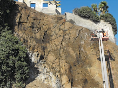 The nozzlemen had to be hoisted more than 60 feet in lifts to spray apply the shotcrete.
