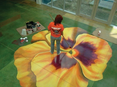 The polished concrete floors at an international gardening and nursery company's new headquarters were accented with four painted flower blossoms.