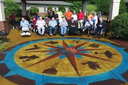Residents of Ballard Western Kentucky Veterans Center in front of the decorative concrete work members of the ASCC's DCC installed at the center's therapeutic garden.