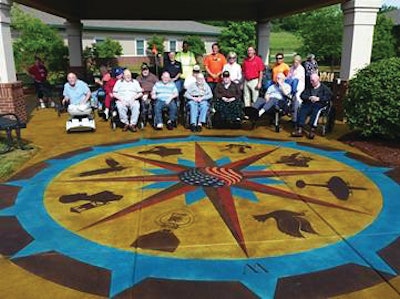 Residents of Ballard Western Kentucky Veterans Center in front of the decorative concrete work members of the ASCC's DCC installed at the center's therapeutic garden.