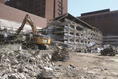 Strict vibration restrictions were a main challenge during demolition of a 5-story parking garage attached to a functioning hospital.