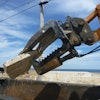 The Mega Beak allows OBPM Construction to precisely pick apart a house or concrete slab and crush the material into more manageable pieces for loading into dumpsters.