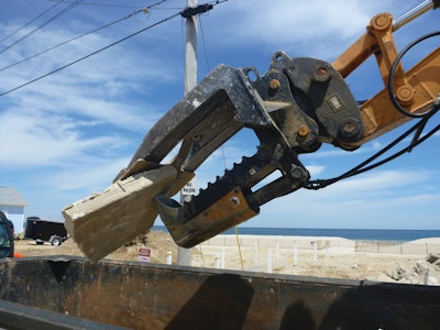 The Mega Beak allows OBPM Construction to precisely pick apart a house or concrete slab and crush the material into more manageable pieces for loading into dumpsters.