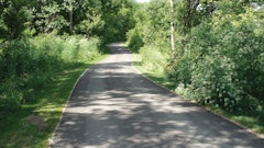 E&B was contracted to build a trail that ran .7 miles through an area that was completely covered in brush and trees, which wound along the river and under the Carroll Bridge.