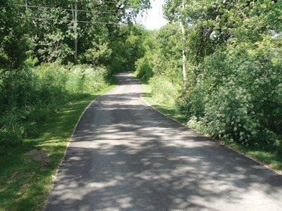 E&B was contracted to build a trail that ran .7 miles through an area that was completely covered in brush and trees, which wound along the river and under the Carroll Bridge.