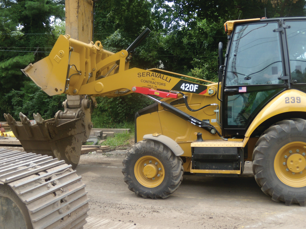 Dumping buckets of stone into an excavator bucket of a Cat 345.