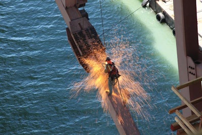 The Grand Prize was awarded to California Department of Transportation Engineer Martin Chandrawinata for his photograph of an iron worker using a cutting torch while suspended from the San Francisco-Oakland Bay Bridge.