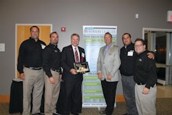 Alan Rose (holding plaque) accepts his Lifetime Achievement Entrepreneurial Excellence Award at a Sept. 11 ceremony. With Rose are some of his Rose Paving support (from left) Todd Dembinski, Larry Briar, Rose, Tim Chimack, Julio Chinea and Paul Price.