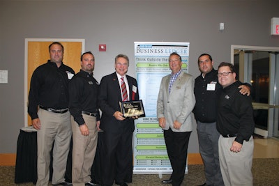 Alan Rose (holding plaque) accepts his Lifetime Achievement Entrepreneurial Excellence Award at a Sept. 11 ceremony. With Rose are some of his Rose Paving support (from left) Todd Dembinski, Larry Briar, Rose, Tim Chimack, Julio Chinea and Paul Price.