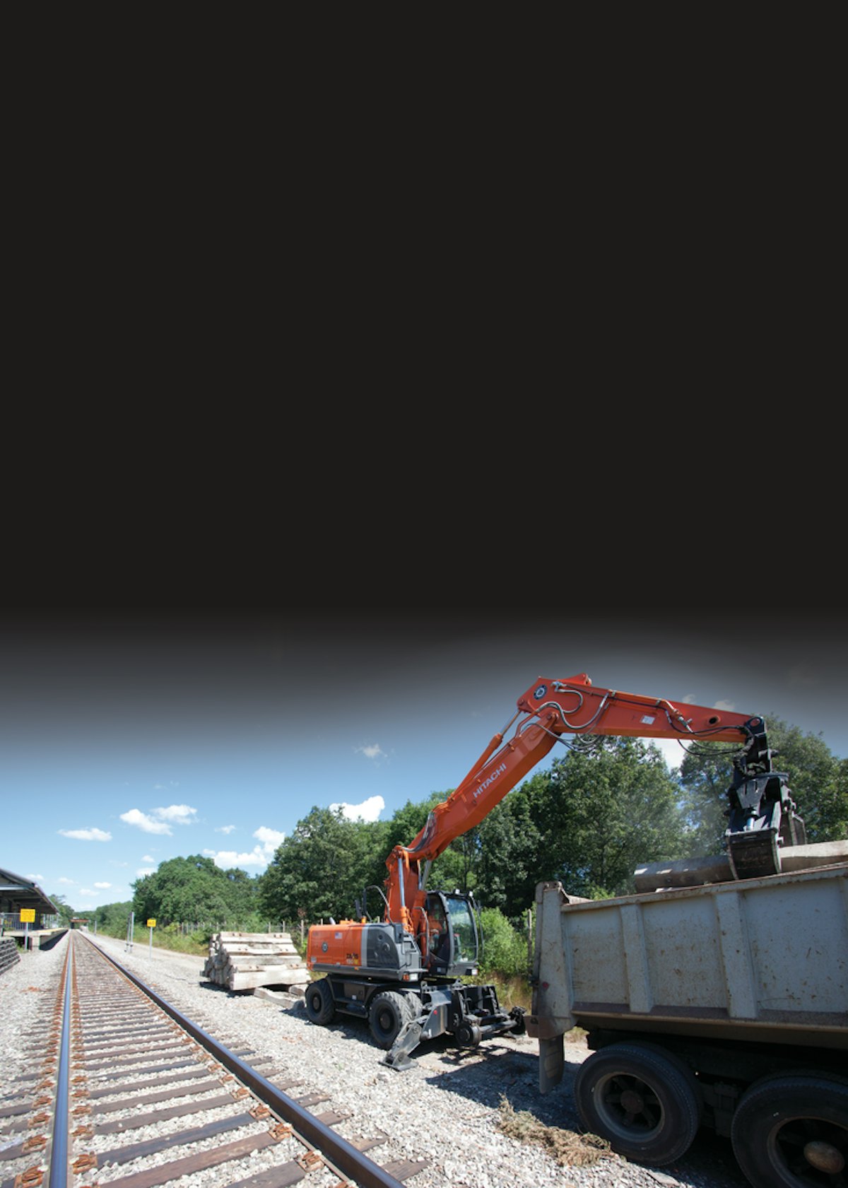 Three Trains of Excavators Rebuilds Commuter Railway Ahead