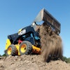 If you are trying to dump into a truck that exceeds the lifting height capacity of your machine, you can simply open the jaws of a 4-in-1 bucket and let material flow out
