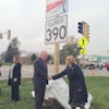 A sign displaying the new name of the Elgin-O'Hare Expressway, Illinois Route 390, was unveiled after the official ground-breaking ceremony. (Pictured from left: Illinois Tollway Executive Director Kristi Lafleur, Governor Pat Quinn, and IDOT Transportation Secretary Ann Schneider.)