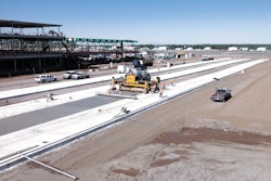 Proform Concrete Services' Commander III concrete paver is paving the new apron 20 ft. wide and 15 in. thick in six paving passes.