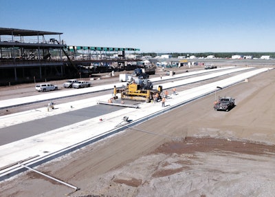 Proform Concrete Services' Commander III concrete paver is paving the new apron 20 ft. wide and 15 in. thick in six paving passes.