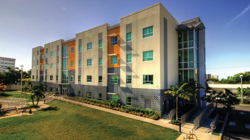 There was no access on three sides of the building, so the walls, structural steel, and hollow-core planks had to be erected from inside the building footprint.