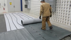 Hydronic heaters provide an even distribution of heat to the concrete. Here, a poly sheet covers a slab-on-grade. Hydronic heating tubes were placed on top of the poly and the entire system is being covered with insulated blankets.