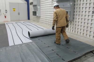 Hydronic heaters provide an even distribution of heat to the concrete. Here, a poly sheet covers a slab-on-grade. Hydronic heating tubes were placed on top of the poly and the entire system is being covered with insulated blankets.
