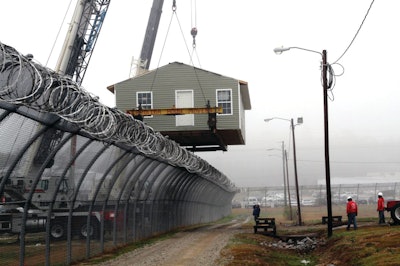 To lift the approximately 33,000-lb. structure over the fence, White Crane operated both cranes at a 95-ft. boom length at a 45-ft. radius.