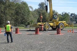 Crane Operator Skills Championship contestant navigates a suspended barrel through the Barrel Slalom at a qualifying event for the 2014 championship.