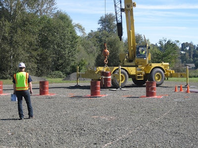 Crane Operator Skills Championship contestant navigates a suspended barrel through the Barrel Slalom at a qualifying event for the 2014 championship.
