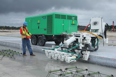 By attaching the Minnich A-4SCW to a 750-cfm portable air compressor, Archer Western's crew was able to employ a fully contained, fully powered unit that could be driven down the slab via remote control.
