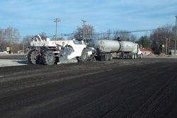 A reclaimer and emulsion tanker introduce emulsion to the RAP, placed on top of a cement-treated subgrade.